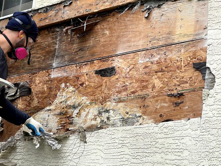 Damaged exterior material removal during Calgary renovation