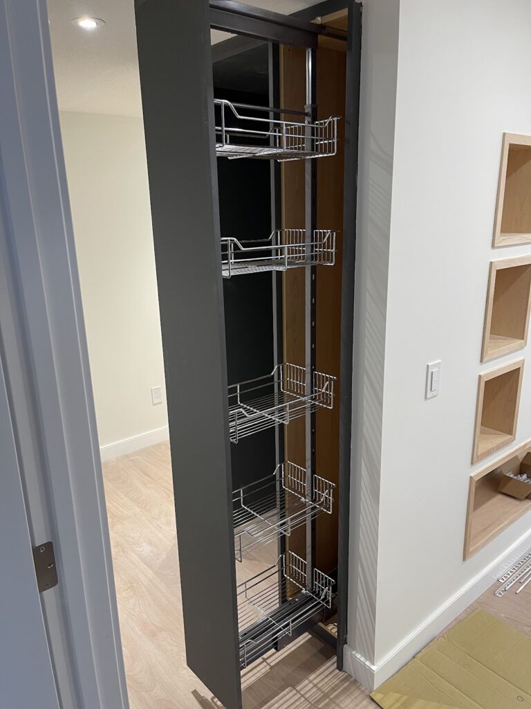 Custom built-in storage cabinetry with shelves and drawers in Calgary home