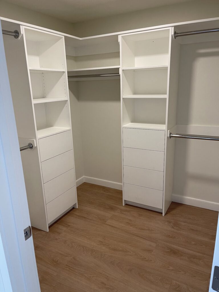 Custom walk-in closet with built-in shelving and storage in Calgary home