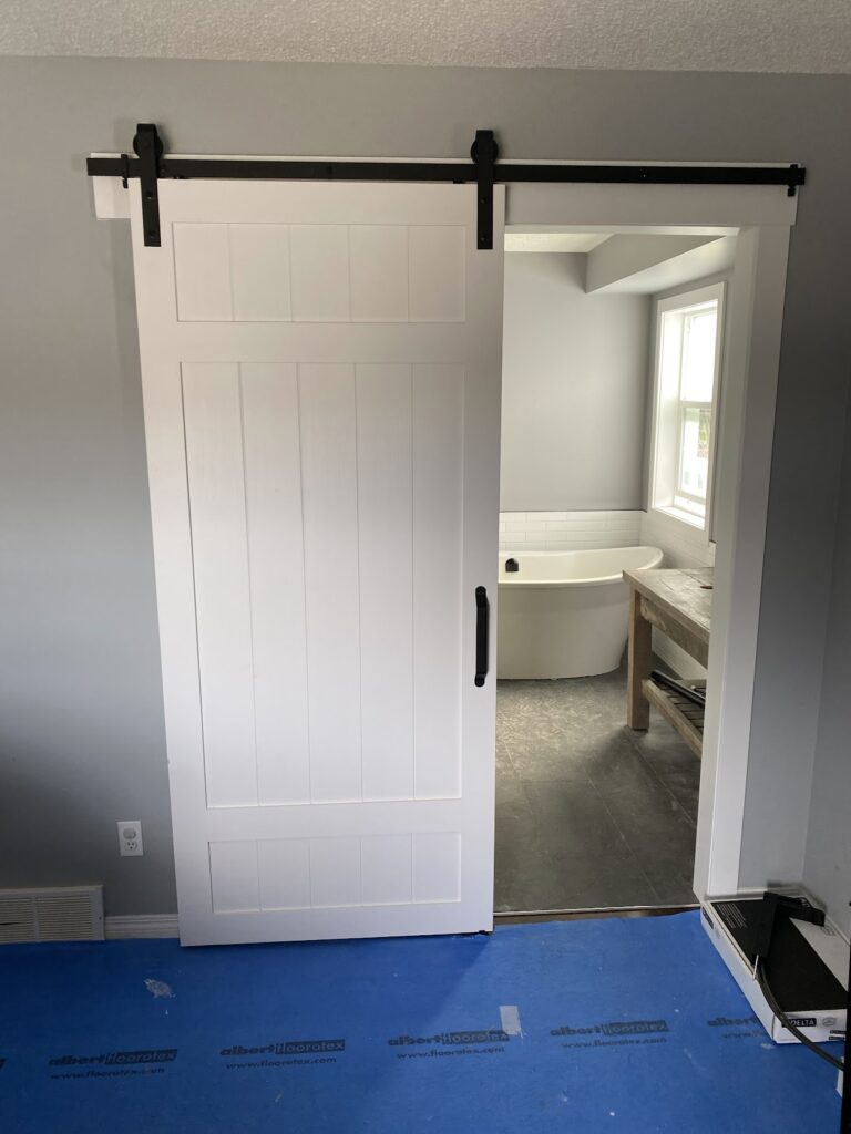Sliding barn-style interior door installed during Calgary renovation