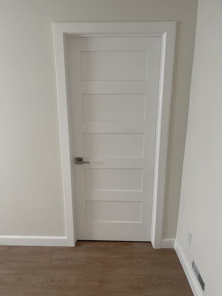 Finished interior door and trim work in renovated Calgary home