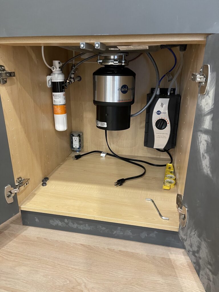 Built-in utility storage cabinetry and service area in Calgary home